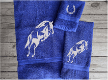 Load image into Gallery viewer, Blue bath towel set or individual towels, embroidered jumping horse is the perfect design for the horse living family, that English decor. This Luxury horse towel set of 3 towels 1 bath towel, 1 hand towel, 1 wash cloth. Personalize the towel set with a name and an initial on the wash cloth or just the designs - Borgmanns Creations - 2
