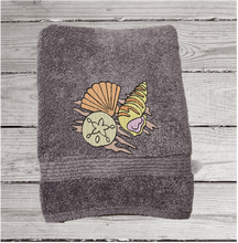 Load image into Gallery viewer, Gray bath towel with embroidered  sea shells is 15&quot; x 55&quot;  can be purchased with a hand and washcloth as a set. Personalized bathroom lake decor wonderful towel set for your home decor, housewarming gift or wedding gift. Borgmanns Creations 2
