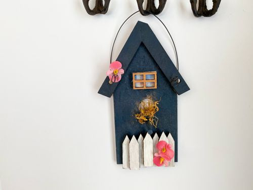 Single birdhouse, laser cut, layered wood white picket fence, blue acrylic paint, flowers, hung by wire, 8 1/2