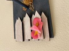 Load image into Gallery viewer, Single birdhouse, laser cut, layered wood white picket fence, blue acrylic paint, flowers, hung by wire, 8 1/2&quot; H x 5 1/2&quot; W x 1 1/2. D. A gift for the bird lover to decorate their home. This birdhouse wall hanging is a unique house warming gift or birthday gift - Borgmanns Creations 
