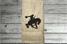 Load image into Gallery viewer, Beige Bath hand towel - silhouette bronc and rider - western rodeo ranch decor - work towel - horse lover gift - kitchen, bath or bar decor - home decor - birthday gift for him - Borgmanns Creations
