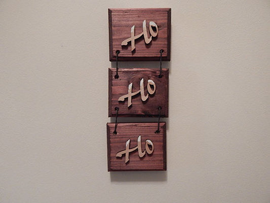 HO HO HO 3 piece wall hanging - home decor gift for mom - Laser cut lauan wood letters and glued to a 1" beveled edge wood mahogany stained  - acrylic paint at top of letters for snow - 3 pieces held together by twisted wire - hanging hook on back - 11 1/2" x 4 1/4" - Borgmanns Creations 