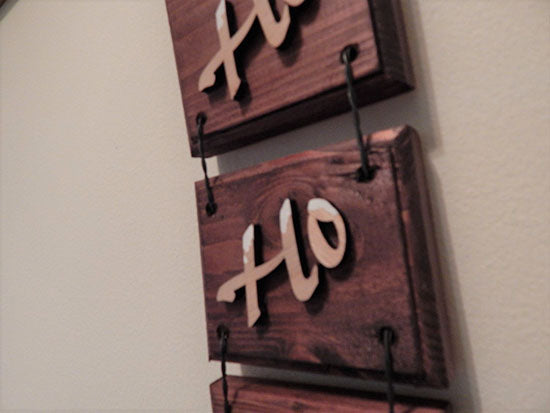 HO HO HO 3 piece wall hanging - home decor gift for mom - Laser cut lauan wood letters and glued to a 1" beveled edge wood mahogany stained - acrylic paint at top of letters for snow - 3 pieces held together by twisted wire - hanging hook on back - 11 1/2" x 4 1/4" - Borgmanns Creations
