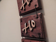 Load image into Gallery viewer, HO HO HO 3 piece wall hanging - home decor gift for mom - Laser cut lauan wood letters and glued to a 1&quot; beveled edge wood mahogany stained - acrylic paint at top of letters for snow - 3 pieces held together by twisted wire - hanging hook on back - 11 1/2&quot; x 4 1/4&quot; - Borgmanns Creations
