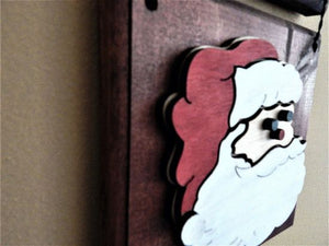 Santa Face wall hanging - Christmas decor gift for mom - wood wall plaque - laser cut lauan wood glued to a 1" beveled edge wood with mahogany stain, hanging hook on back - housewarming gift teacher gift gift for a coworker - 11" x 7" - Borgmanns Creations