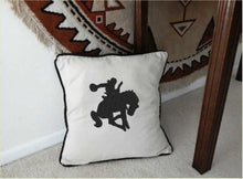 Load image into Gallery viewer, Throw pillow cover, natural color cotton material, black piping around the edge, 18&quot;x 18&quot; or 20&quot; x 20&quot;, embroidered silhouette of a bronc rider, Will make a wonderful western accent pillow for your couch, chair, bed, office, or to decorate your entryway - Borgmanns Creations
