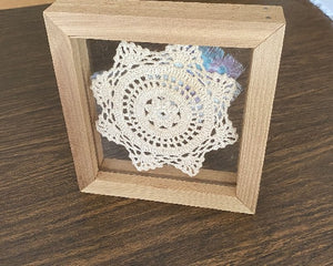 Crochet doily -  one of a kind wall hanging, or it can stand alone on any side -  wonderful gift country farmhouse decor - bedroom decor ideas for your home or a special gift - doily is vintage star pattern between 2 pieces of acrylic and framed in wood-  a piece of material to complement the doily - 7 1/8" H x 7 1/8" W x 1 1/4" D- Borgmanns Creations - 6
