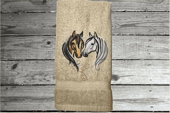 Beige hand towel for a horse lovers gift, this classy embroidered design of 2 horse heads on a luxury terry hand towel, 16" x 27", will make your bathroom or kitchen decor, country western decor for the farmhouse family.  Personalize this towel as a gift for a friend, birthday gift or house warming gift - Borgmanns Creations  - 1