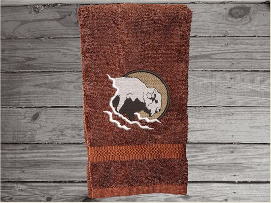 Brown hand towel embroidered Southwest decor with buffalo head will make the west come alive. A terry hand towel 16" x 27" is just the gift for the Southwest theme for bathroom or kitchen, to make the romance of the old west come alive. Will make a wonderful farmhouse housewarming gift or for your own home. decor - Borgmanns Creations - 3
