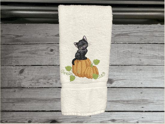 White hand towel, beautiful design of a cat sitting on a pumpkin, decorative towel for the bathroom or kitchen to brighten up your Halloween decor. You can personalize it for a gift to a friend or family member. The terry towel, 16" x 30", is soft and absorbent for any home decor - Borgmanns Creations - 1