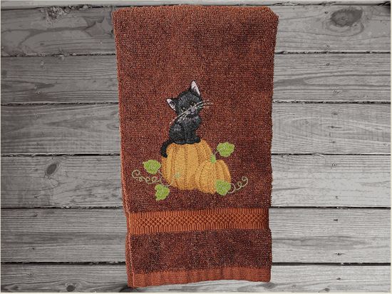 Brown hand towel, beautiful design of a cat sitting on a pumpkin, decorative towel for the bathroom or kitchen to brighten up your Halloween decor. You can personalize it for a gift to a friend or family member. The terry towel, 16" x 27", is soft and absorbent for any home decor - Borgmanns Creations - 3
