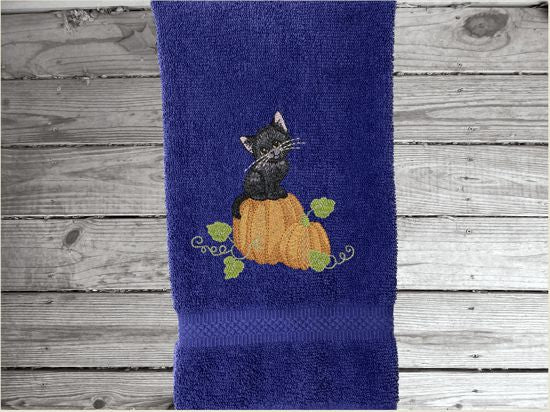 Blue hand towel, beautiful design of a cat sitting on a pumpkin, decorative towel for the bathroom or kitchen to brighten up your Halloween decor. You can personalize it for a gift to a friend or family member. The terry towel, 16" x 27", is soft and absorbent for any home decor - Borgmanns Creations - 4