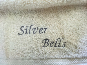 Beige hanging towel - silver bells - perfect Christmas gift for mom with embroidered words Silver Bells for her kitchen decor - It can also be hooked over a bathroom cabinet handle - home decor premium terry towel is 16" wide - 21" long - Borgmanns Creations - 