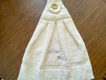 Load image into Gallery viewer, Beige hanging towel - silver bells - perfect Christmas gift for mom with embroidered words Silver Bells for her kitchen decor - It can also be hooked over a bathroom cabinet handle - home decor premium terry towel is 16&quot; wide - 21&quot; long - Borgmanns Creations - 3
