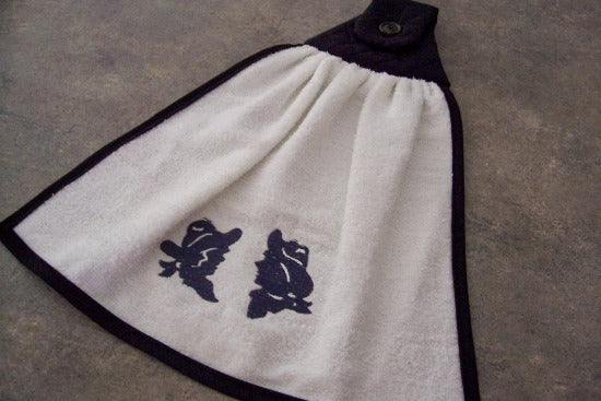 Kitchen hanging towel - embroidered cowboy and cowgirl heads - terry towel with black quilted top, edged with bias tape, embroidered design and dark button 15" wide - 18" long - farmhouse decor gift for mom with the country flair kitchen decor - hangs over oven handle or cabinet handle - Borgmanns Creations - 1