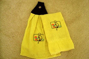 Yellow kitchen towel set - embroidered anchor and fish design for the kitchen - design is embroidered on both towels hand towel also has the words "going fishing" - the top of hanging towel is black quilted material with button - fisherman can keep it with fishing equipment - hand towel 13" x 22" - hanging towel 16 1/2" x 13" - Borgmanns Creations - 1