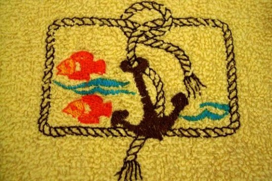 Yellow kitchen towel set - embroidered anchor and fish design for the kitchen - design is embroidered on both towels hand towel also has the words "going fishing" - the top of hanging towel is black quilted material with button - fisherman can keep it with fishing equipment - hand towel 13" x 22" - hanging towel 16 1/2" x 13" - Borgmanns Creations - 4