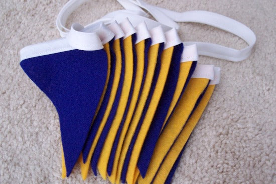 Party banner, blue and gold felt flags, 19 flags each 3 1/2" x 4 1/2" of soft felt sewn to bias tape, The flag section is 6 feet and there is 2ft of white bias tape on each side for tying. Great for the kids room, photo prop, high school, collage, etc. Wonderful decoration for any party. Easy to store and reuse - Borgmanns Creations 