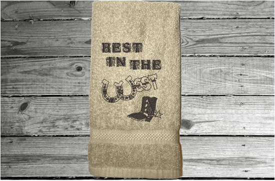 Beige western hand towel, terry towel, soft and absorbent, 16" x 27", embroidered design "Best in The West" with horseshoe and cowboy boot, for your spouse for your anniversary or their birthday to display in the bathroom or kitchen - Borgmanns Creations 