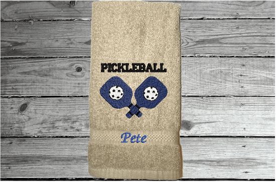 Beige Pickleball hand towel - embroidered rackets and ball on a terry towel  soft and absorbent 16" x 27", for the hard playing player. Personalized gift for a special person or for the teem. Birthday gift for mom or dad.  Borgmanns Creations 1