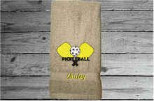 Load image into Gallery viewer, Beige Pickleball hand towel, embroidered rackets and ball on a terry towel 16&quot; x 27&quot; for the hard playing player. Personalized gift for a special person or for the teem. Birthday gift for mom or dad. Borgmanns Creations  3
