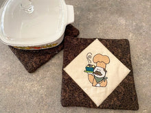 Load image into Gallery viewer, Pot holder set, 2 layers of Insul-Bright in the center, diamond shaped unbleached muslin with embroidered chef design,  brown floral pattern around design and on the back  7&quot; x 7&quot;, great gift for mom&#39;s farmhouse kitchen decor, embroidered for the cook at the outdoor BBQ pit, or the chef indoors - Borgmanns Creations 

