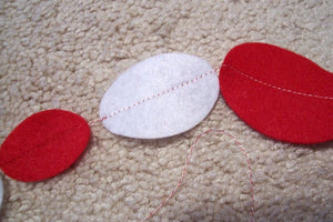 Holiday garland banner decoration for celebrating Valentines Day, Mothers Day or just a great decoration for any party - red and white felt ovals sewn together to made into a banner - there is 2ft of tie off at each end - Borgmanns Creations - 2