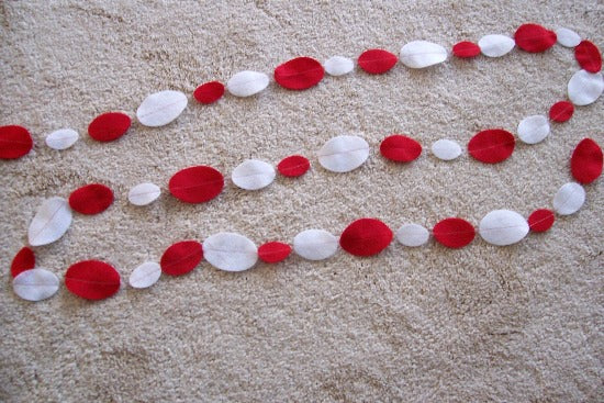 Holiday garland banner decoration for celebrating Valentines Day, Mothers Day or just a great decoration for any party - red and white felt ovals sewn together to made into a banner - there is 2ft of tie off at each end - Borgmanns Creations - 3