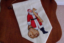 Load image into Gallery viewer, White Christmas Santa wall hanging banner - backing of polyester material - embroidered Santa with scroll and bag - hung on dowel stick and hung with jute  - Borgmanns Creations 2
