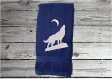 Load image into Gallery viewer, Blue wolf hand towel, beautiful design of a howling wolf under the moon, embroidered on a terry towel,  soft and absorbent, 16&quot; x 27&quot;, a home decor addition for a farmhouse bathroom, kitchen for guest bath - Borgmanns Creations 
