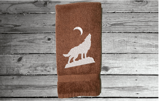Brown wolf hand towel, beautiful design of a howling wolf under the moon, embroidered on a terry towel,  soft and absorbent, 16" x 27", a home decor addition for a farmhouse bathroom, kitchen for guest bath - Borgmanns Creations 