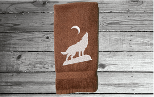 Brown wolf hand towel, beautiful design of a howling wolf under the moon, embroidered on a terry towel,  soft and absorbent, 16" x 27", a home decor addition for a farmhouse bathroom, kitchen for guest bath - Borgmanns Creations 