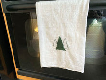 Load image into Gallery viewer, Tea towels flour sack brighten up your kitchen decor this year with this tea towel with 3 Christmas trees embroidered on it, for the kitchen is where every one gathers. Make it a gift for your friend, a housewarming gift, or a teachers holiday gift. Details flour sack tea towel 29&quot; x 29&quot; embroidered  - Borgmanns Creations
