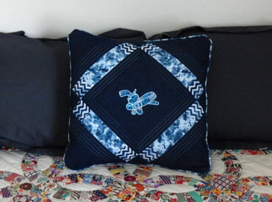Throw pillow cover of a western gun and holster set will make a unique home decor gift for the western theme home. 20" x 20" blue denim material, a diamond shape blue and white fabric to set off the embroidered design, quilted top, piping around edge, blue backing for opening in back. Embroidered and quilted custom wedding gift for the new couple's gift -Borgmanns Creations