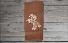 Load image into Gallery viewer, Brown bathroom hand towel - horse design western home decor - personalized horse lovers gift - embroidered hand towel - perfect western farmhouse design - gift for mom - bathroom or kitchen decor - Borgmanns Creations 1
