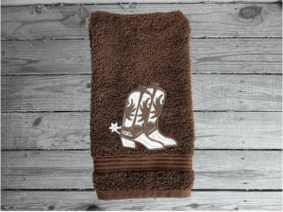 Brown hand towel , cowboy hat and boots is the perfect design for that farmhouse decor. This Luxury western theme towel set 3 towels 1 bath towel 27"x55", 1 hand towel 16"x28", 1 wash cloth 13" x 13". You can personalize the towel set with a name and an initial on the wash cloth or just the designs. Borgmanns Creations