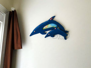 Wood wall art this wood sculpture of a porpoise, 1/2"  MDF board, layered wood, hand painted, wire, flowers,  material, hanger on back, 12" H x 18" W x 1/2" D, for that baby shower gift. Also great for a shelf sitter or even leaning against a wall at floor level. One of a kind baby shower gift - Borgmanns Creations 