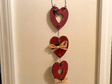 Load image into Gallery viewer, 3 Hearts - Wood Wall Hanging - 2 Hearts Have Open Centers - Hung By Wire And Connected By Wire - With Small Flowers and Raffia to Finish It Off -Borgmanns Creations
