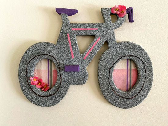 Wood wall hanging this wood sculpture of a bike will make a wonderful baby shower gift for girls room. 1/2" MDF board, layered wood, hand painted with gray acrylic paint, pink stripes, purple seat, handle bars an peddle, decorated with flowers, wire, and material, hanging hook on the back. The perfect gift you may be looking for - Borgmanns Creations