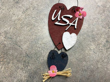 Load image into Gallery viewer, Wood wallart &quot;USA&quot; laser cut Luan wood, wire attaches 2 pieces, acrylic paint, glued together, flowers and raffia to complete the wall art, 10&quot; x 4&quot; including wire hanger, wall art will add to your home decor for the holidays, kitchen, living room, den or hallway. Perfect summer and 4th of July decoration - Borgmanns Creations 
