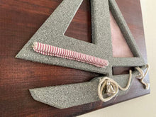 Load image into Gallery viewer, Gray sailboat, red white sails, rope, and bell mounted on a oak wood beveled and mahogany stained 13&quot; W x 11&quot; H x 3/4&quot; D- nautical wall Hanging - Borgmanns Creations
