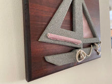 Load image into Gallery viewer, Gray sailboat, red white sails, rope, and bell mounted on a oak wood beveled and mahogany stained 13&quot; W x 11&quot; H x 3/4&quot; D- nautical wall Hanging - Borgmanns Creations
